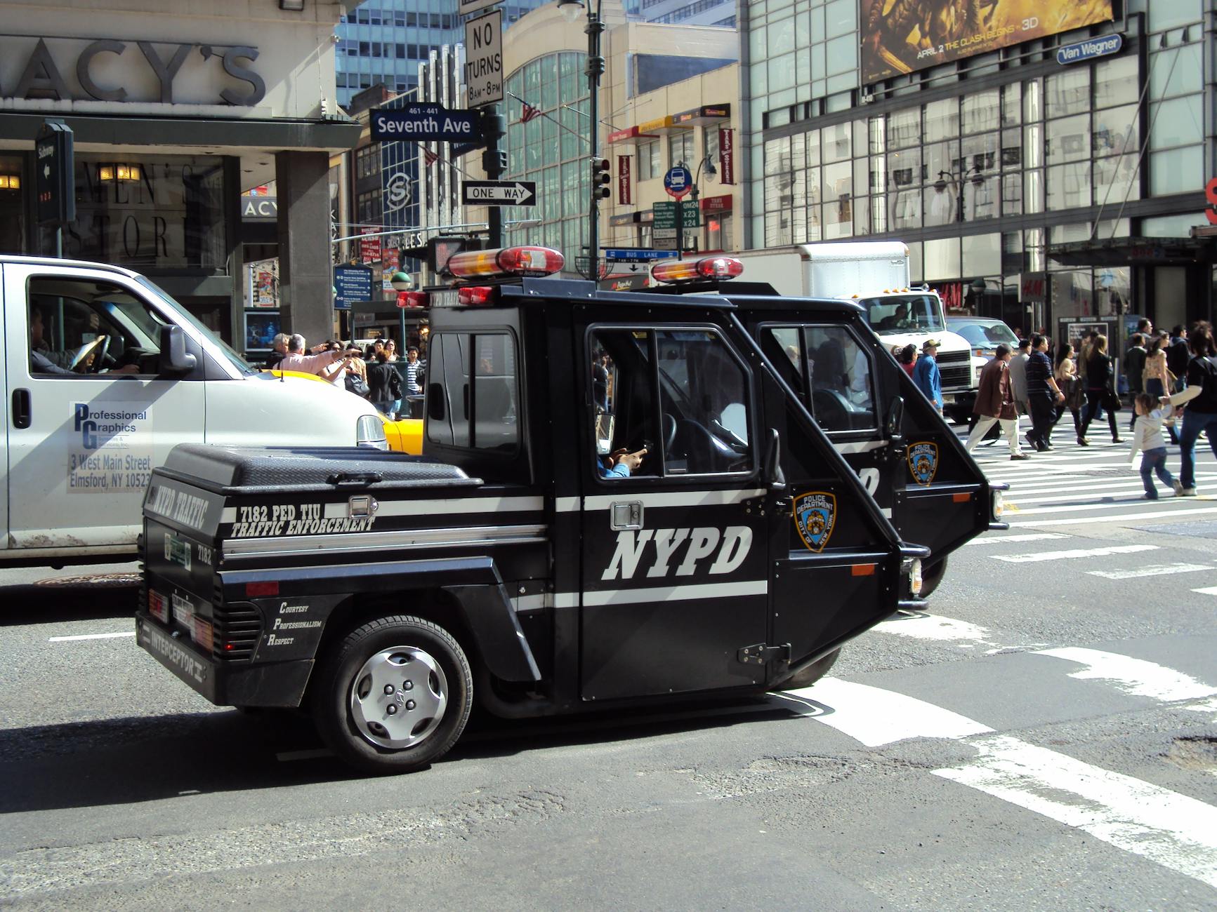 NYPD traffic enforcement vehicle patrolling busy New York City streets.