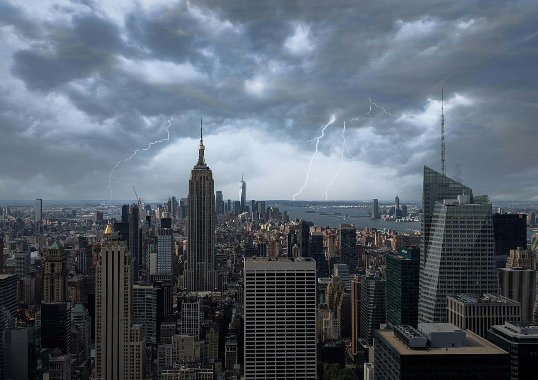 Striking view of New York City skyline with a lightning storm and Empire State Building.